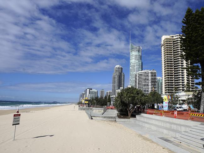 A deserted Surfers Paradise Beach on Gold Coast, Wednesday, April 8, 2020. Three major Gold Coast beaches have been cordoned off overnight, to stop beach goers gathering on the sand. The Spit, Coolangatta and Surfers Paradise beaches will remain closed for the foreseeable future, as a coronavirus lockdown measure taken by Council. (AAP Image/Dave Hunt) NO ARCHIVING.