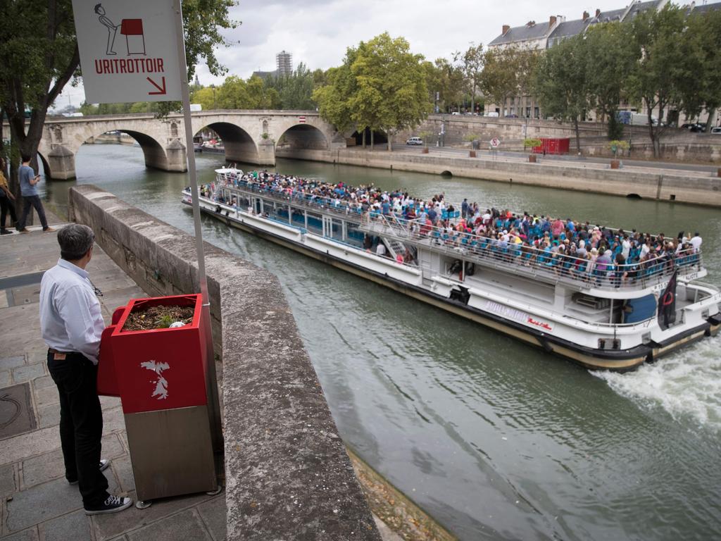 A man stands gives the public urinal a whirl. Picture: Thomas Samson/AFP