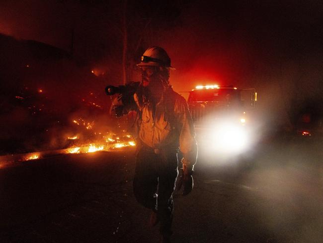 A firefighter monitors flames by the Hughes Fire in Castaic, California. Picture: AP