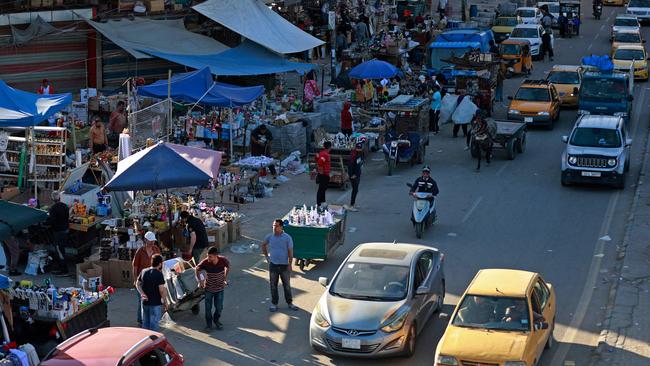 People shop at the Shorja market in the centre of Baghdad this week, 20 years after the start of the US-led invasion that toppled Saddam Hussein. Picture: AFP