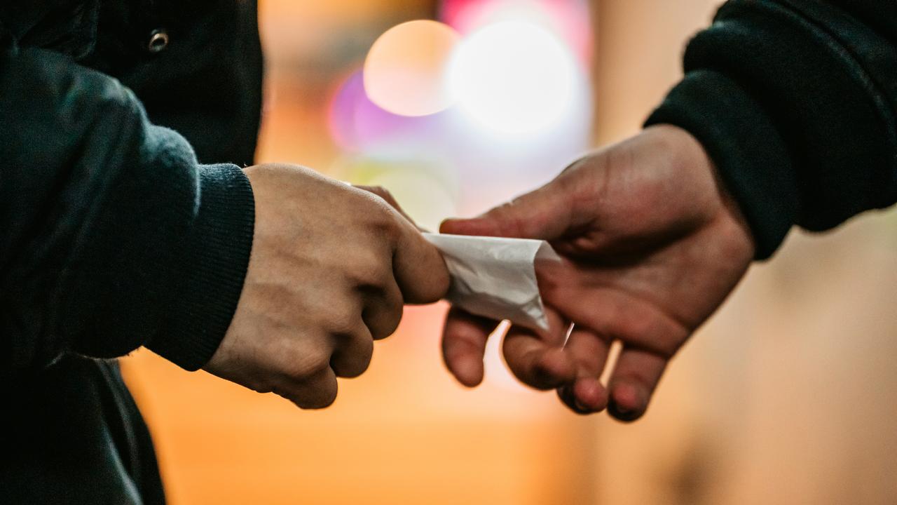 Addict young man have meeting with dealer at night to buy dose of white powder cocaine.