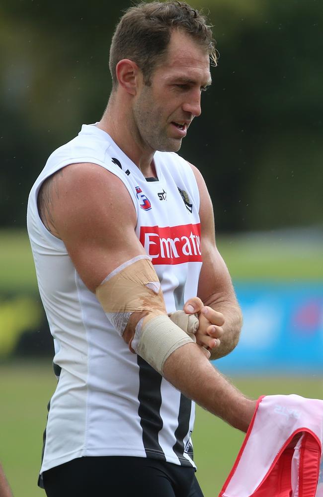 Travis Cloke leaves the training track with his elbow heavily strapped. Picture: Hamish Blair