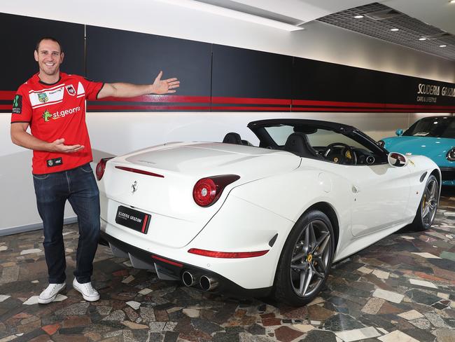 St George rugby league fan Andrew Raptis gets up close and personal with a Ferrari California T at the Scuderia Graziani car dealership in Woolloomooloo. Picture: Brett Costello