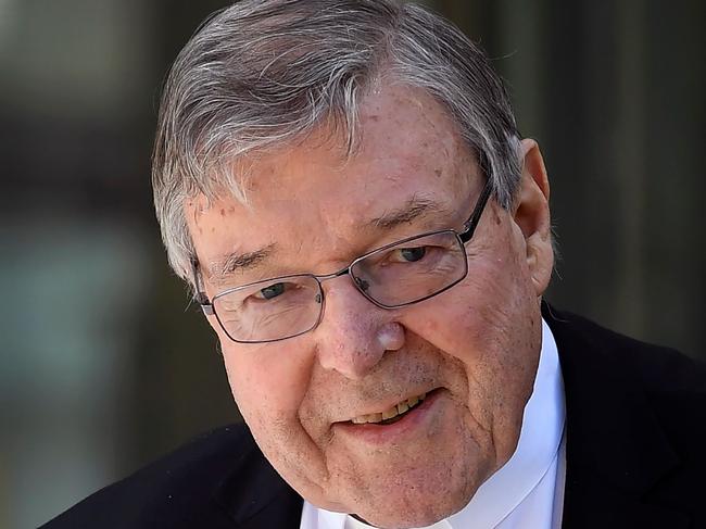 (FILES) This file photo taken on December 10, 2018 shows Cardinal George Pell walking to a car in Melbourne. - Cardinal George Pell was aware of child sexual abuse by Catholic clergy in Australia as far back as the 1970s and failed to seek the removal of accused priests, according to parts of a top-level inquiry released on May 7, 2020. (Photo by William WEST / AFP)