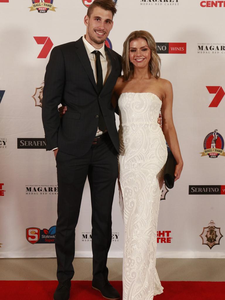 Tyson Brown and Alana Salzborn, wearing Nooki, pose for a picture on the red carpet at Adelaide Oval in North Adelaide, for the Magarey Medal, Monday, September 9, 2019. Picture: Matt Loxton