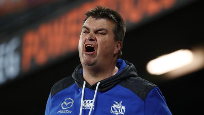 An angry Kangaroos fan lets his feelings be known during Saturday’s loss to Melbourne.