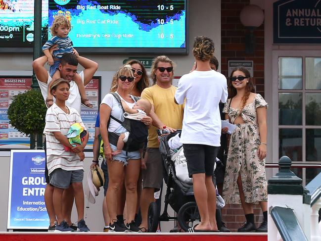 Local surfing legend Mark Occhilupo (yellow shirt) arrives at Dreamworld with family yesterday. Picture: Adam Head