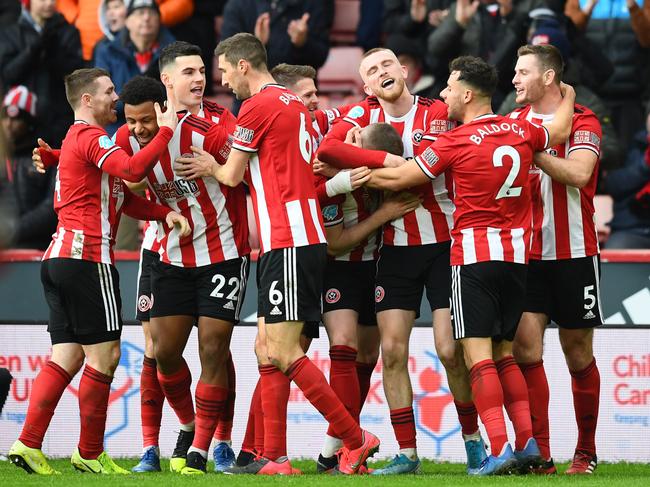 SHEFFIELD, ENGLAND - FEBRUARY 09: John Lundstram of Sheffield United celebrates with his team mates after scoring his team's second goal during the Premier League match between Sheffield United and AFC Bournemouth  at Bramall Lane on February 09, 2020 in Sheffield, United Kingdom. (Photo by Clive Mason/Getty Images)