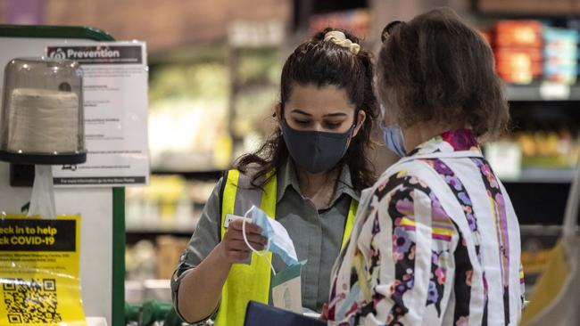 Woolworths staff hand out masks to shoppers at Bondi Junction. Picture / Monique Harmer