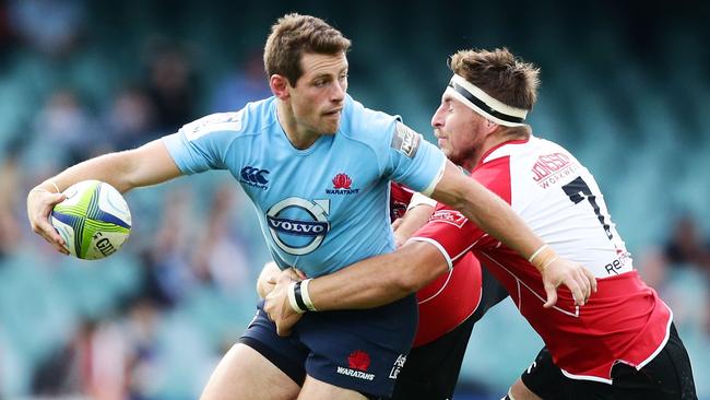 SYDNEY, AUSTRALIA - MAY 18: Bernard Foley of the Waratahs takes on the defence during the round 14 Super Rugby match between the Waratahs and the Lions at Allianz Stadium on May 18, 2014 in Sydney, Australia. (Photo by Matt King/Getty Images)