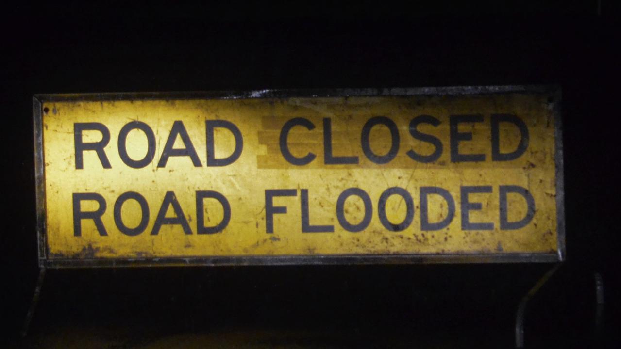 IF IT'S FLOODED FORGET IT: Warning signs have been placed around Oxford Downs Sarina Rd after two vehicles were swept away in flood waters within about an hour on June 4.