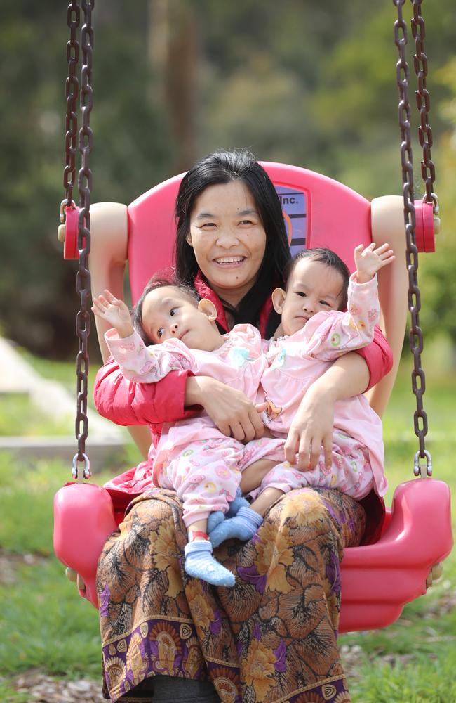 Mum Bhumchu Zangmo holds Nima [left], and Dawa [right] in a swing at the Children First Foundation Miracle Smiles Retreat in Kilmore. Picture: Alex Coppel