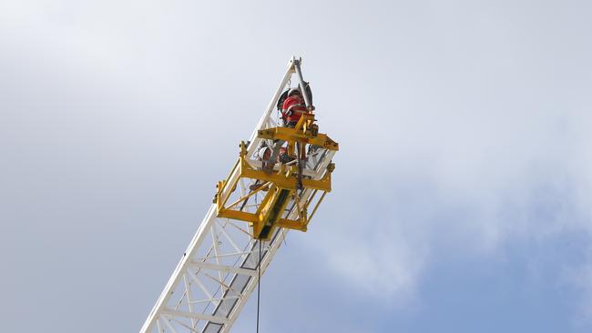 Workmen repair a crane snapped that its cable and dropped its 400kg hook to the ground. Picture Glenn Hampson