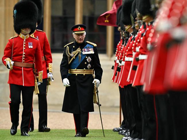 Britain's King Charles III (C) reviews the Irish Guards during a ceremony where he presents New Colours to No 9 and No 12 Company The Irish Guards at Windsor Castle, west of London, on June 10, 2024. The new Colours will be those trooped in the Trooping of the Colour at His Majestyâs official Birthday Parade in London on Saturday June 15, 2024. (Photo by Ben Stansall / POOL / AFP)