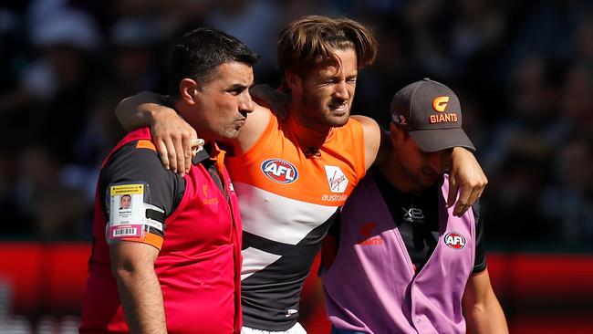 Callan Ward is helped from the ground after suffering an ACL injury on Saturday. Picture: Michael Willson/AFL Photos/Getty Images.