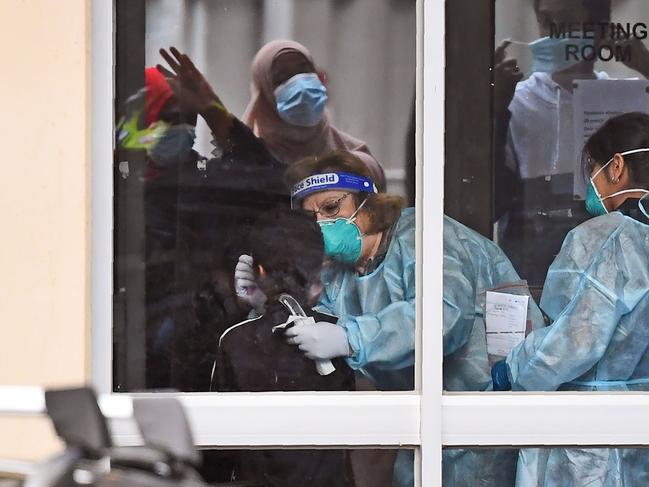 Medical staff perform a Covid test on a resident of a housing estate in Melbourne. Picture: AFP