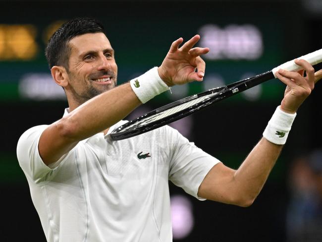 LONDON, ENGLAND - JULY 08: Novak Djokovic of Serbia celebrates winning match point with a violin gesture against Holger Rune of Denmark in his Gentlemen's Singles fourth round match during day eight of The Championships Wimbledon 2024 at All England Lawn Tennis and Croquet Club on July 08, 2024 in London, England. (Photo by Mike Hewitt/Getty Images)