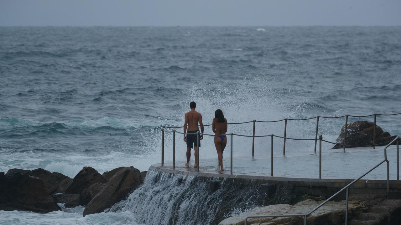 Swimmers still braced the ocean despite the weather warning on Saturday. Picture: NCA NewsWire / Max Mason-Hubers