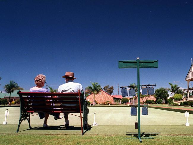 Retirees Leila Stock and Mal Jones sitting on a bench at Cleveland Gardens Retirement Village Qld. / Housing / Aged couple man woman retirement generic