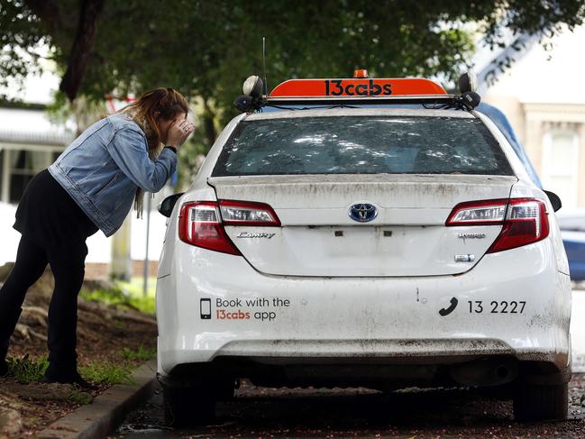 A resident takes a closer look at a taxi in Burt St, Rozelle. Picture: Sam Ruttyn