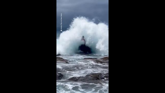 Man posing hit with a huge wave