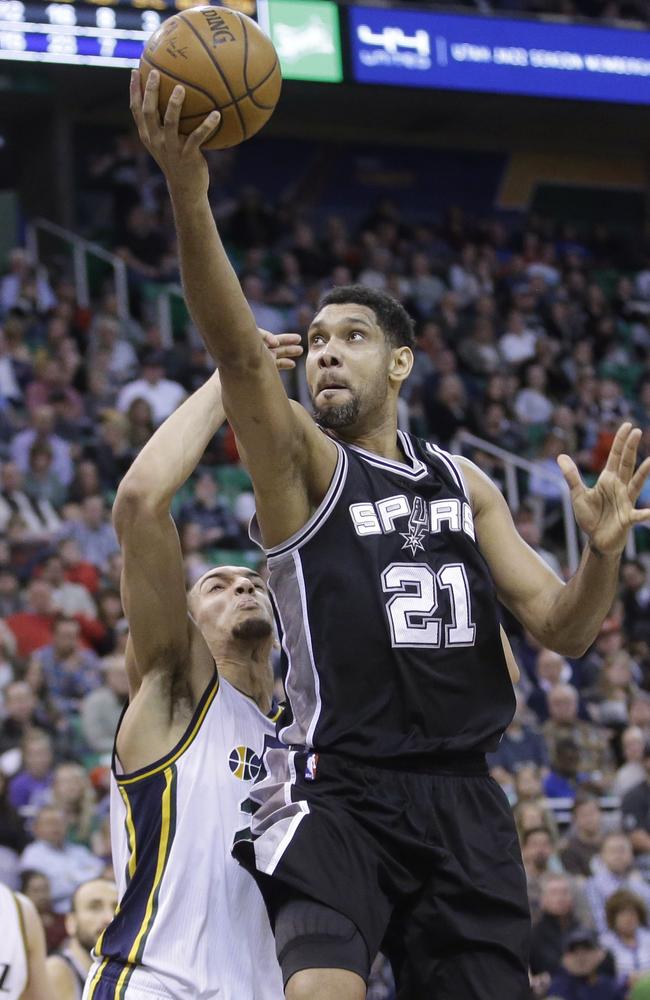 San Antonio Spurs forward Tim Duncan (21) lays the ball up as Utah Jazz centre Rudy Gobert, left, defends in the second quarter.