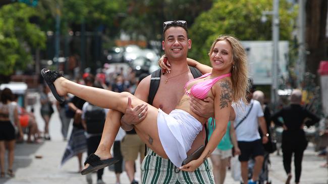 Melbournians Andy Dimopoulos and Betty Petri are keen to let their hair down and enjoy their holiday on the Gold Coast, but would like to do so without state government requirements. Pic Mike Batterham