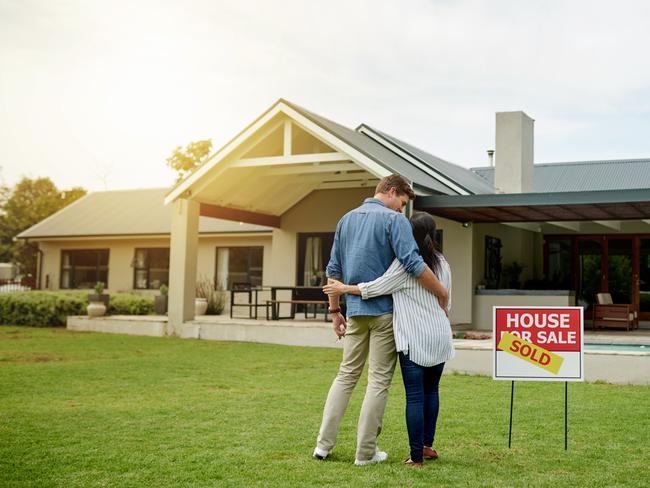 generic; couple in front of house for sale; house sold; real estate; hugging; iSTOCK