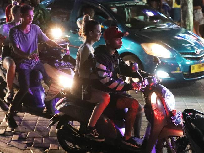 Young Australians riding on scooters without helmets. Picture: Liam Kidston