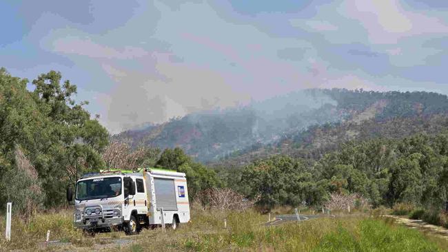 Emergency services at the scene of multiple fires on Mount Morgan range on September 22, 2024. SES have road blocks on the Burnett Hwy as Queensland Fire Brigade crews battle the fires, including using a helicopter to drop water from the air.