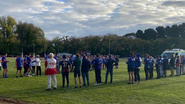 Spectators watch on as the ambulance leaves. Picture: Supplied