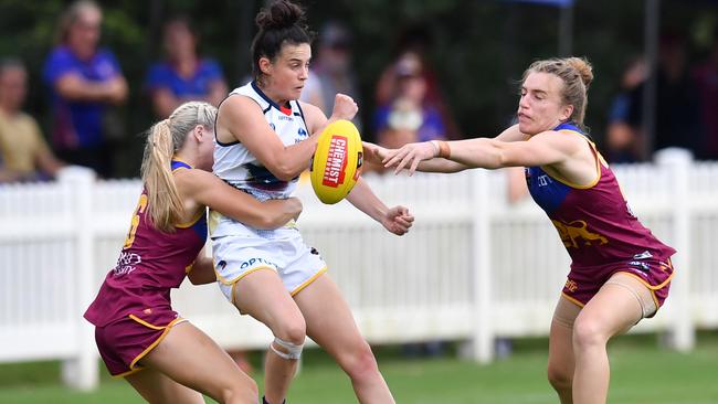 CAUGHT IN A WEB: Crow Eloise Jones (centre) is dispossessed by Lions Lily Postlethwaite (left) and Maria Moloney last week. Picture: DARREN ENGLAND (AAP).