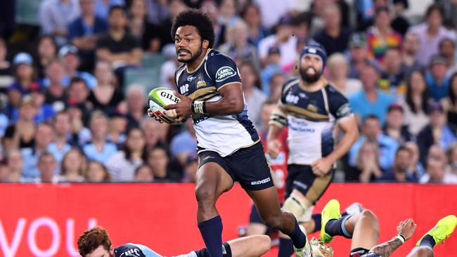 Henry Speight of the Brumbies gets through the tackles by Andrew Kellaway and Israel Folau.