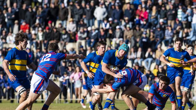 Oliver Chaffey of Grammar is tackled by Jake Stephens of Downlands in O'Callaghan Cup on Grammar Downlands Day at Downlands College, Saturday, August 6, 2022. Picture: Kevin Farmer