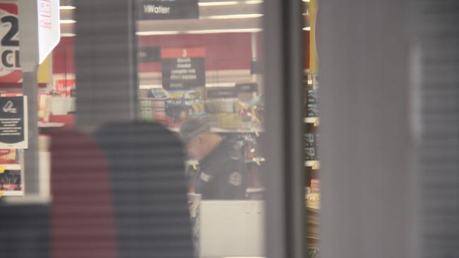 Police inside Coles in Alice Springs. Picture: Gera Kazakov