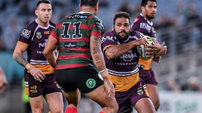 Sam Thaiday prepares to take on John Sutton.