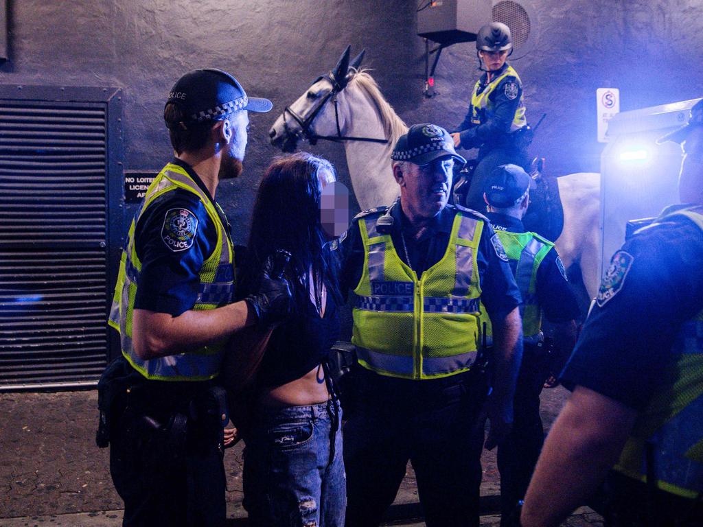 Police with a woman in Hindley Street in the early hours of 2020. Picture: AAP / Morgan Sette