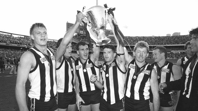 Damian Monkhorst, Craig Kelly, Darren Millane, Scott Russell, Shane Kerrison, Doug Barwick, Gavin Brown (obscured) and Craig Starcevich with the 1990 premiership cup.