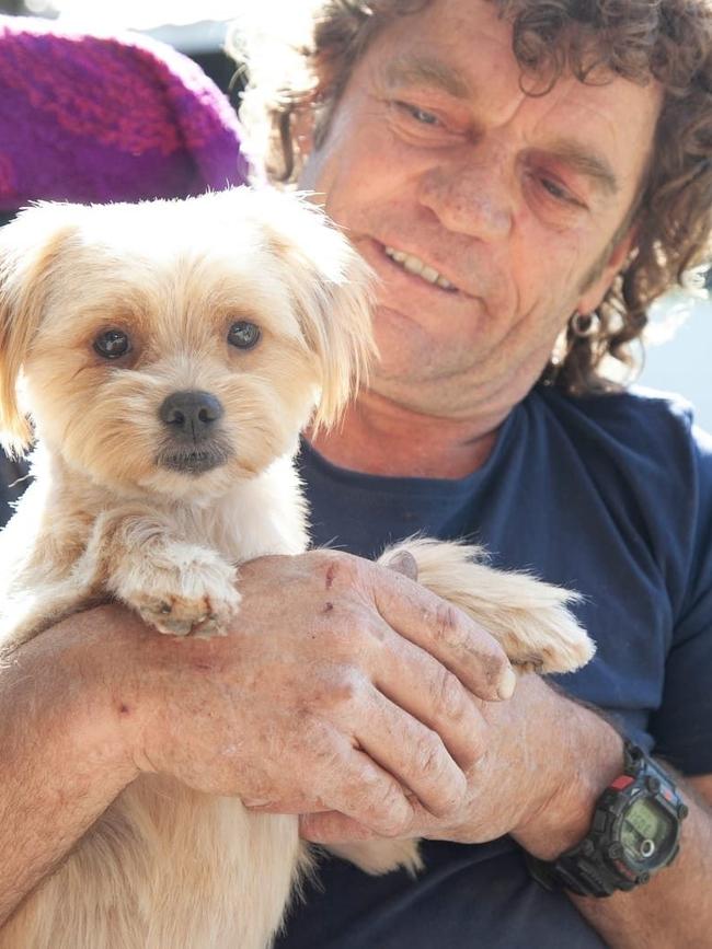 Lifelong Menindee resident Tom Murkins, with his dog Mini, says this is the worst fish kill he has ever seen.