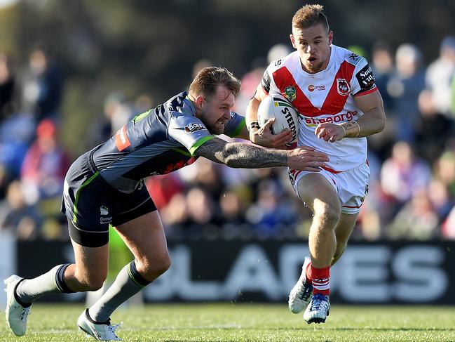 Matthew Dufty tries to give Raider Blake Austin the slip. Picture: AAP