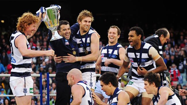 Chris Scott lifts the premiership cup with Geelong in 2011 – his first year as coach.