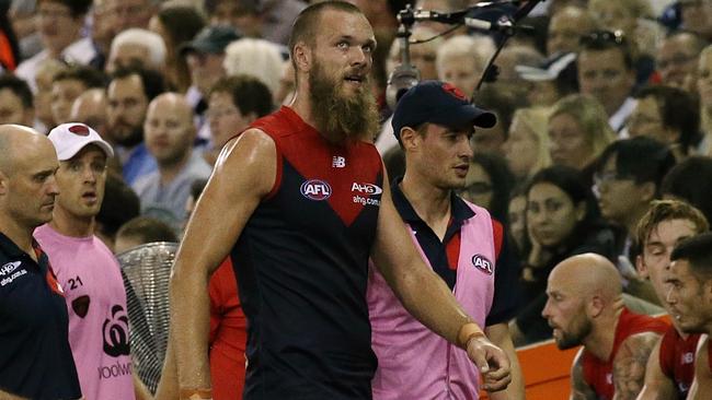 Max Gawn leaves the ground with the help of trainers on Saturday. Picture: Wayne Ludbey