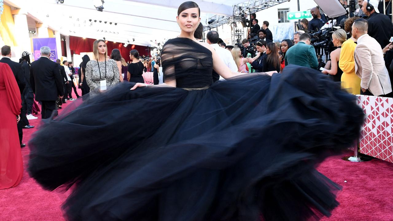 Actress Sofia Carson wears a full-skirted tulle gown with sheer swathed bodice by Giambattista Valli. Picture: AFP