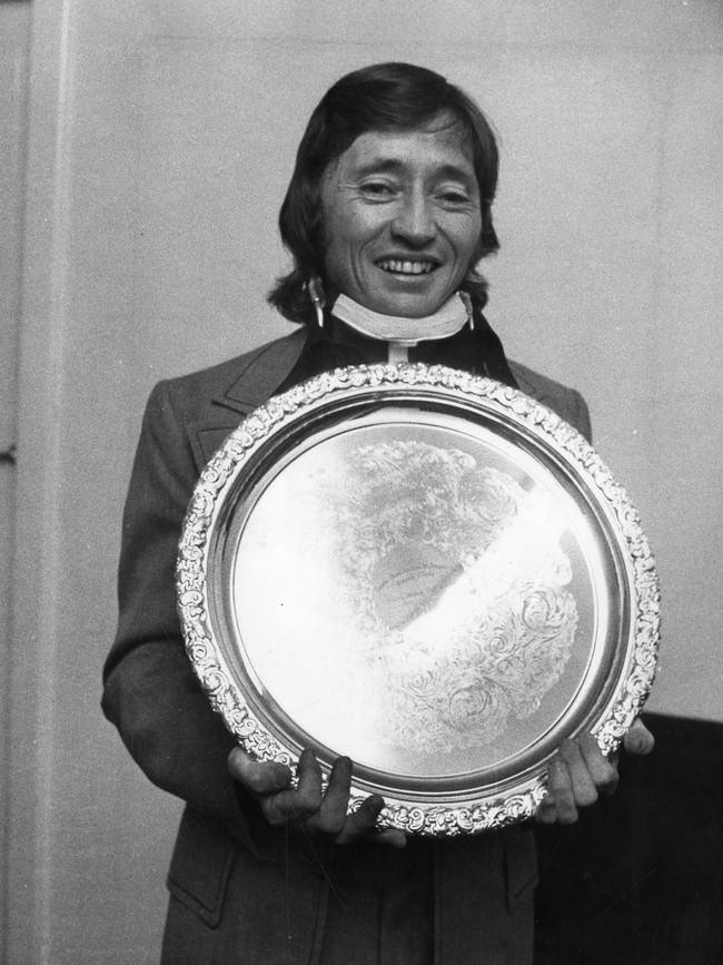 Injured jockey John Letts holds the trophy he received as the State's top rider for the 1973/74 season. Letts received special permission to leave hospital to attend the ceremony.