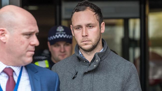 Ryan Wells is escorted by police from the Frankston Law Courts today. Picture: Jake Nowakowski