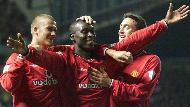 Manchester United's Andy Cole (C) celebrates with teammates David Beckham (L) and Jonathan Greening after scoring against Bradford City during an FA Premier league soccer match at Old Trafford in Manchester 05/09/2000.