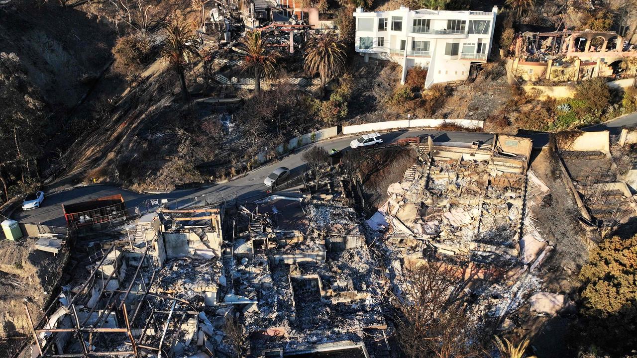 An aerial view of hillside homes destroyed in the Palisades Fire near a home that survived as wildfires cause damage and loss through the LA region. Picture: Getty Images