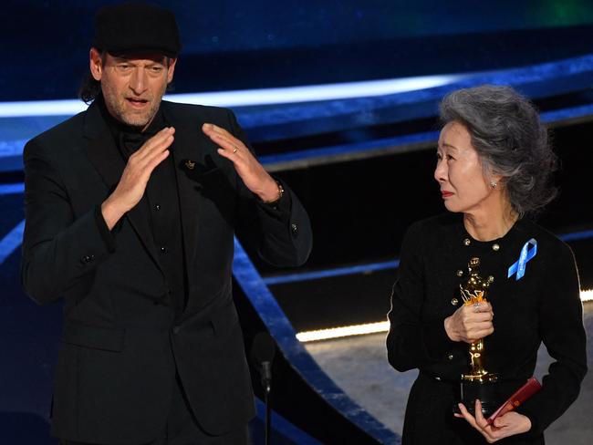 He was presented the award by South-Korean actress Youn Yuh-jung and received a standing ovation. Picture: AFP