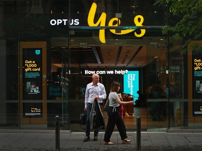 SYDNEY, AUSTRALIA - NOVEMBER 21: Pedestrians walk past an Optus store in the CBD on November 21, 2023 in Sydney, Australia. Optus' CEO Kelly Bayer Rosmarin stepped down on Monday after an extended outage last week caused millions of Australians to be disconnected from the network, with no access to emergency numbers for hours. The outage followed a hack that saw millions of customers' data shared online last year. (Photo by Lisa Maree Williams/Getty Images)