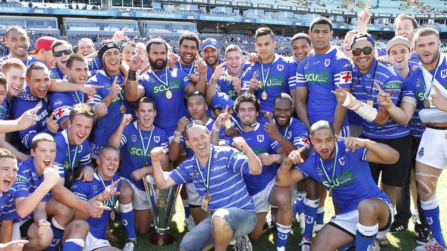 Victory is ours! The 2012 NSW Cup Premiers with their elated head coach. Picture: Mike Biboudis